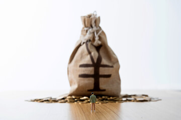 Man figurine and money bag on the table