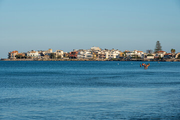 The most beautiful beach in Marzamemi with the city in the background