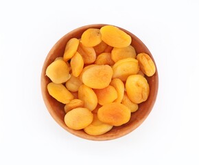 Dried and pitted apricots in a terracotta bowl on a white background