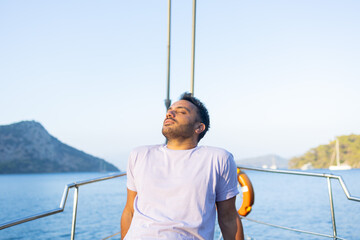 Tourist boy posing on sailing boat. Fun and enjoy concept.