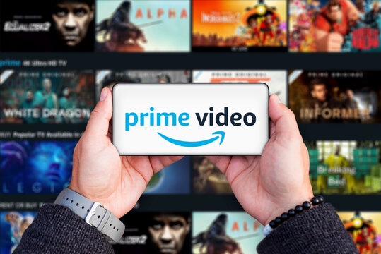 Belgrade, Serbia - October 05, 2022: Holding smartphone in hands with Amazon Prime video logo on screen. Amazon prime is TV series and movie provider platform