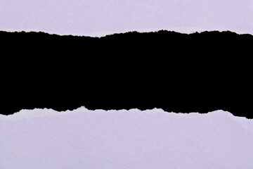 Purple torn paper on black background