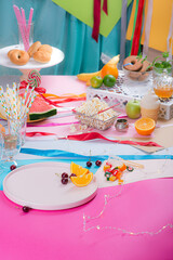 Colorful multicolored table after the party. Lots of food, snacks and drinks.