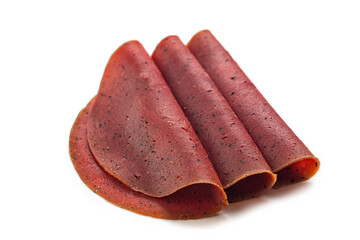 Sliced Spicy Vegan Salami isolated on a white background. Meatless, plant based veggie food, made...