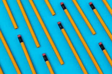 Many unsharpened pencils on blue background