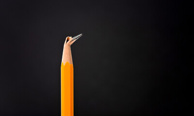 Broken pencil tip on black background