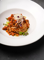 Bolognese pasta on a white plate. Different angles.