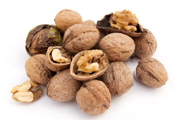 Heap of walnuts and a cracked walnut isolated on the white background