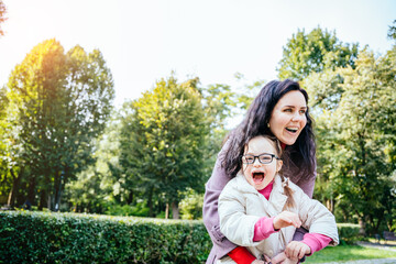 Woman and child enjoy walk autumn sunny day outside. Happy family moments concept. Lovely child in...