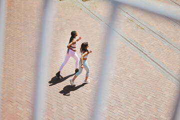 Fitness, exercise and young women running to train for an outdoor sports marathon together....