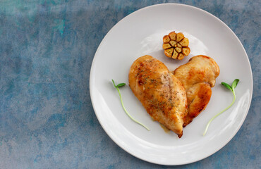 Healthy food grill chicken heart garlic lemon in plate on blue wood background.