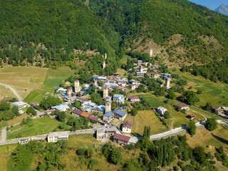 Drone view of the Svan Towers in Mestia on a sunny day, Svaneti region, Georgia. This is a...