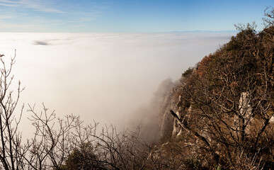 Clouds drift amid rocky cliffs, Trieste