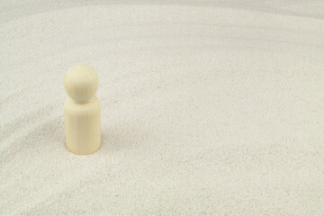 Human figure on white sand background with copy space.	