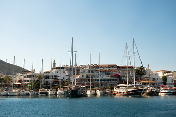Fototapeta na wymiar Yachts Docked At Marmaris Harbour on the Aegean Sea at the sunset near Marmaris in Turkey