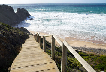 Fototapeta na wymiar wooden stairs leading down to praia do vale dos homens in the Algarve