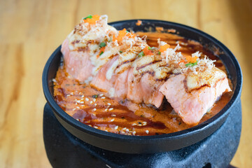 Grilled Salmon sushi with cream salad and spicy sauce placed on a Japanese grill, sushi is a traditional and popular food for Japanese people.