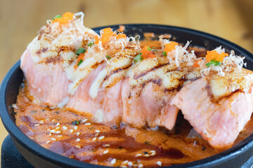 Grilled Salmon sushi with cream salad and spicy sauce placed on a Japanese grill, sushi is a traditional and popular food for Japanese people.