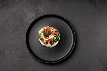 Appetizer with ham, cheese and herbs. Restaurant