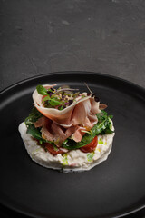 Appetizer with ham, cheese and herbs. Restaurant