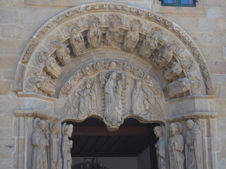 entrance to the college of san jeronimo de santiago de compostela, iconography of santiago apostol, saints and apostles in the columns and arch, tympanum with the virgin and child and saints catalina 