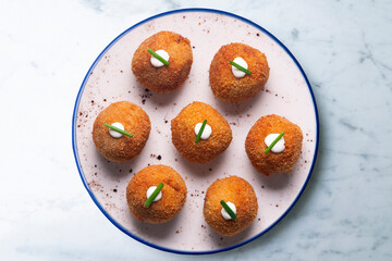 Tapa of typical Spanish croquettes. Made with bechamel and ham. Battered with bread and fried....