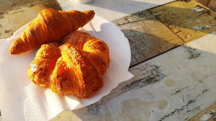 Croissant on a plate on a wooden table