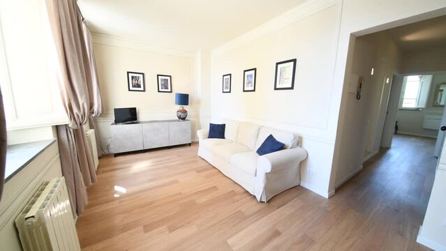 Modern living room with parquet flooring, very bright room with sofa