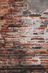 Red brick wall texture. Abstract brick wall background, wall of old, cracked bricks, with a weathered and faded surface. vertical.	