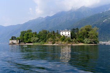 Fototapeta premium Beautiful Brisago Islands seen from passenger ship on a sunny summer day. Photo taken July 25th, 2022, Brisago Islands, Switzerland.