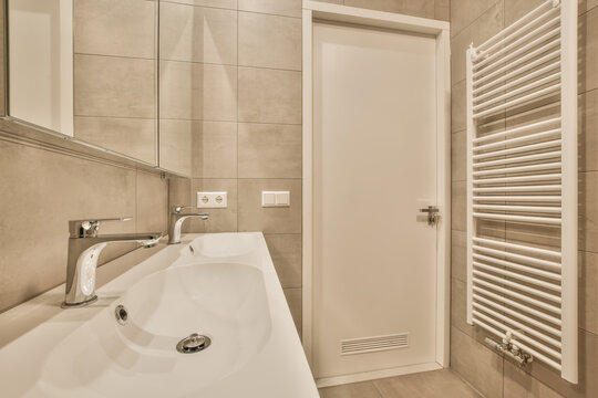 Bathroom with sink on cabinet and mirror heated towel rails