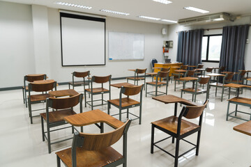 School classroom with many wooden chairs well-arranged in rows with no student