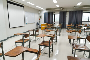 School classroom with many wooden chairs well-arranged in rows with no student