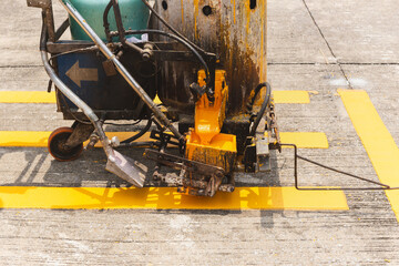 Close up of thermoplastic spray marking machine making lines for painting traffic lines on asphalt...