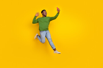 Fototapeta na wymiar Full length body size view of handsome trendy cheery guy jumping taking selfie blog isolated on vivid yellow color background