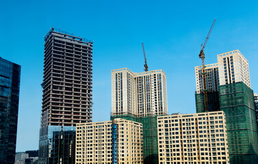 Fototapeta na wymiar New buildings with crane under construction