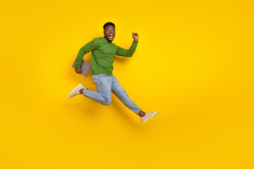Fototapeta na wymiar Full length body size view of handsome trendy guy it expert jumping running isolated over vivid yellow color background
