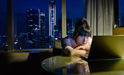 Woman working with laptop at night