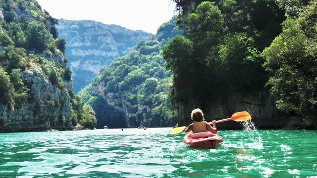 young boy canoeing on the river