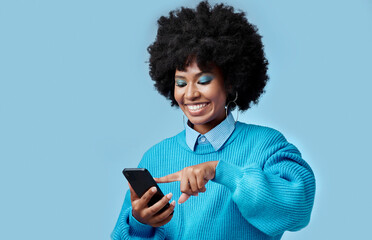 Happy, phone and black woman reading a blog on an internet website in a studio with mockup space....