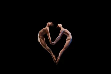 Gardinen Love. Couple of graceful and flexible ballet dancers making heart shape of their bodies isolated over black background. Art, care, support © master1305