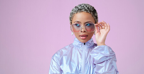 Fashion, beauty and mockup with a black woman in glasses on a pink background in studio for advertising and marketing. Style, edgy and trendy with an attractive female posing with cool sunglasses - Powered by Adobe