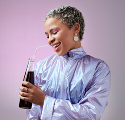 Smile, cola and woman with soda in studio drinking to hydrate and refresh with a cool beverage and straw in a bottle. Happy and young girl in fancy modern clothes enjoys a cold fizzy and tasty liquid