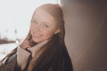 Photo of adorable lovely woman wear grey coat hand arm collar enjoying morning sunshine outside...