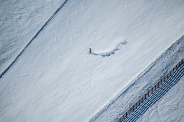 Aerial view of a man skiing on the mountain snow