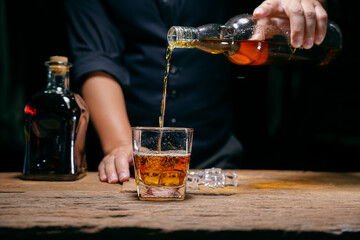 Barman pouring whiskey whiskey glass beautiful night