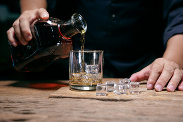 Barman pouring whiskey whiskey glass beautiful night