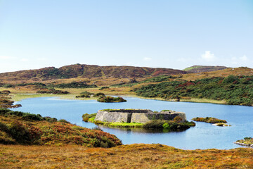 Doon Fort prehistoric stone cashel caiseal or dun. Pre Christian refuge on small crannog lake isle in Doon Lough near Ardara, Donegal, Ireland