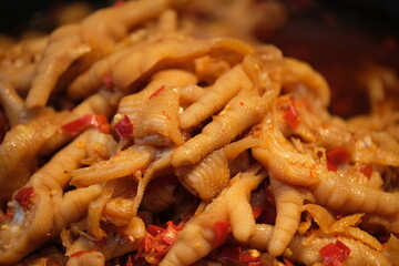 close up spicy chicken feet background. Traditional Chinese food