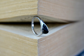 cheap used bijouterie between pages of an old book